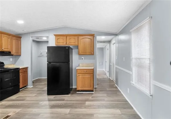 a kitchen with a refrigerator and a stove