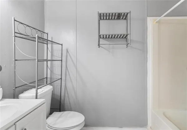 a bathroom with a toilet and a shower