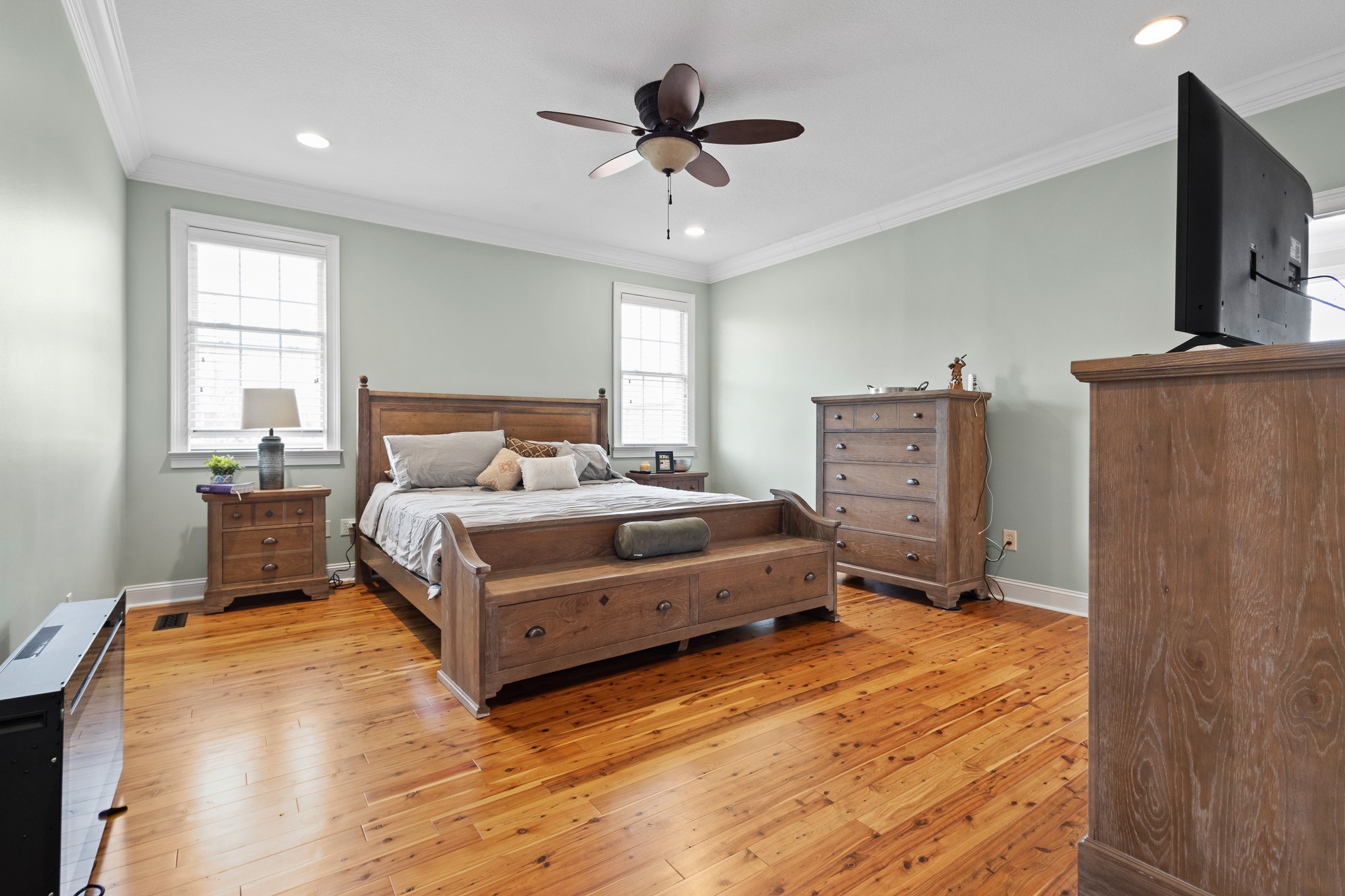 102 Highpoint Boulevard Tullahoma, TN 37388 - Photo 14 of 49 a bedroom with a bed flat screen tv closet and a window
