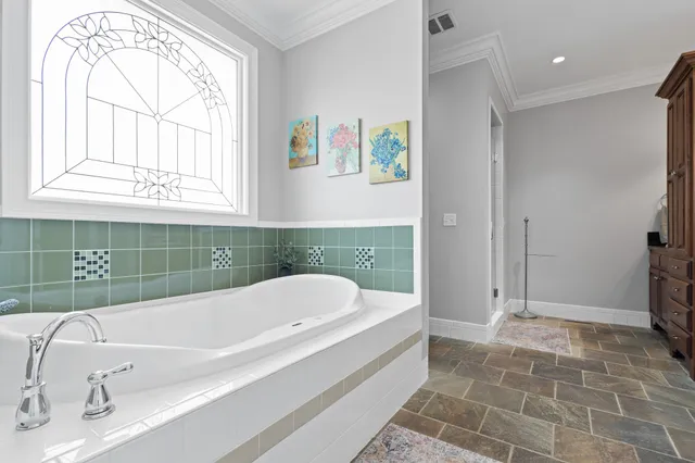 a bathroom with a tub a sink and a shower