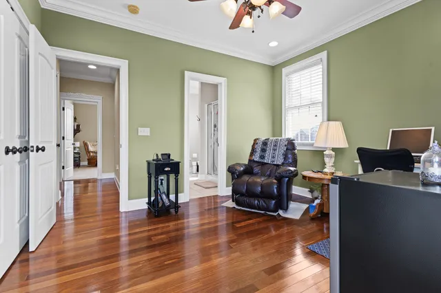a living room with furniture and a wooden floor