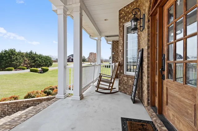 a view of a balcony with a floor to ceiling window and wooden fence