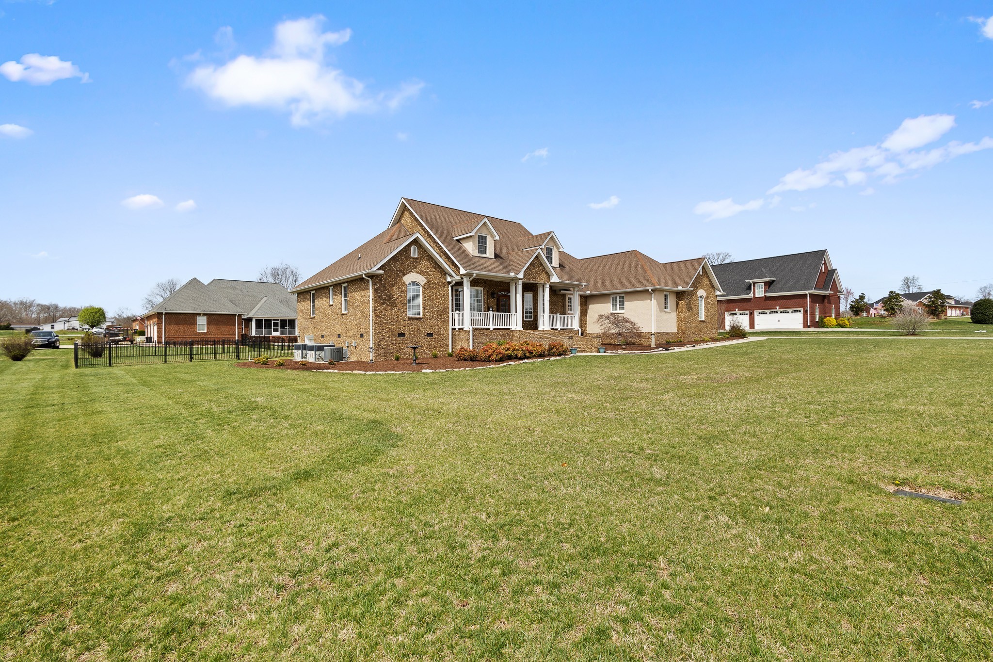 102 Highpoint Boulevard Tullahoma, TN 37388 - Photo 38 of 49 a front view of a house with a garden and lake view