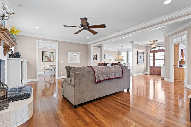 a living room with furniture and a wooden floor