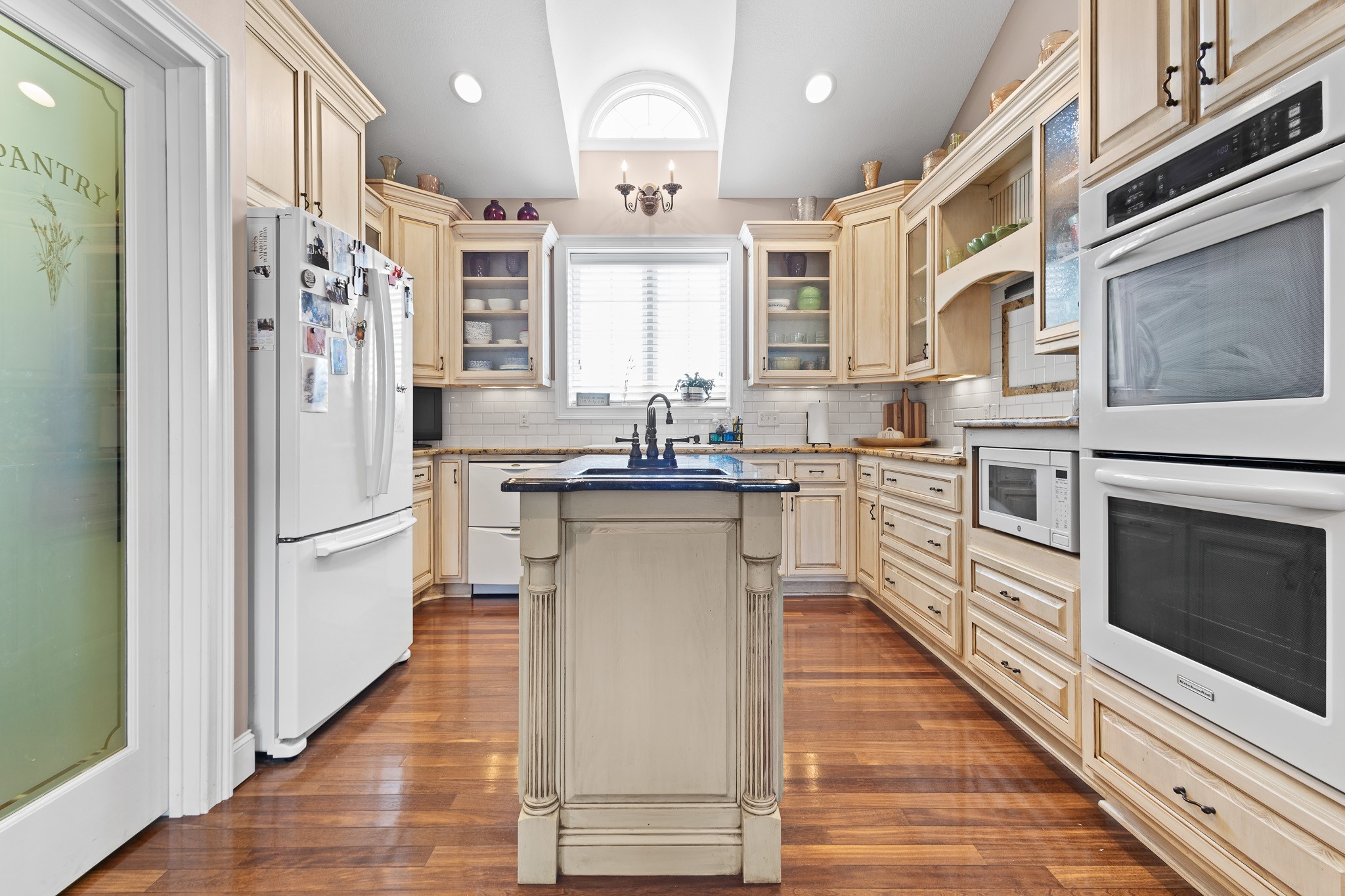 102 Highpoint Boulevard Tullahoma, TN 37388 - Photo 8 of 49 a kitchen with stainless steel appliances granite countertop a refrigerator a sink dishwasher a oven with white cabinets and wooden floor