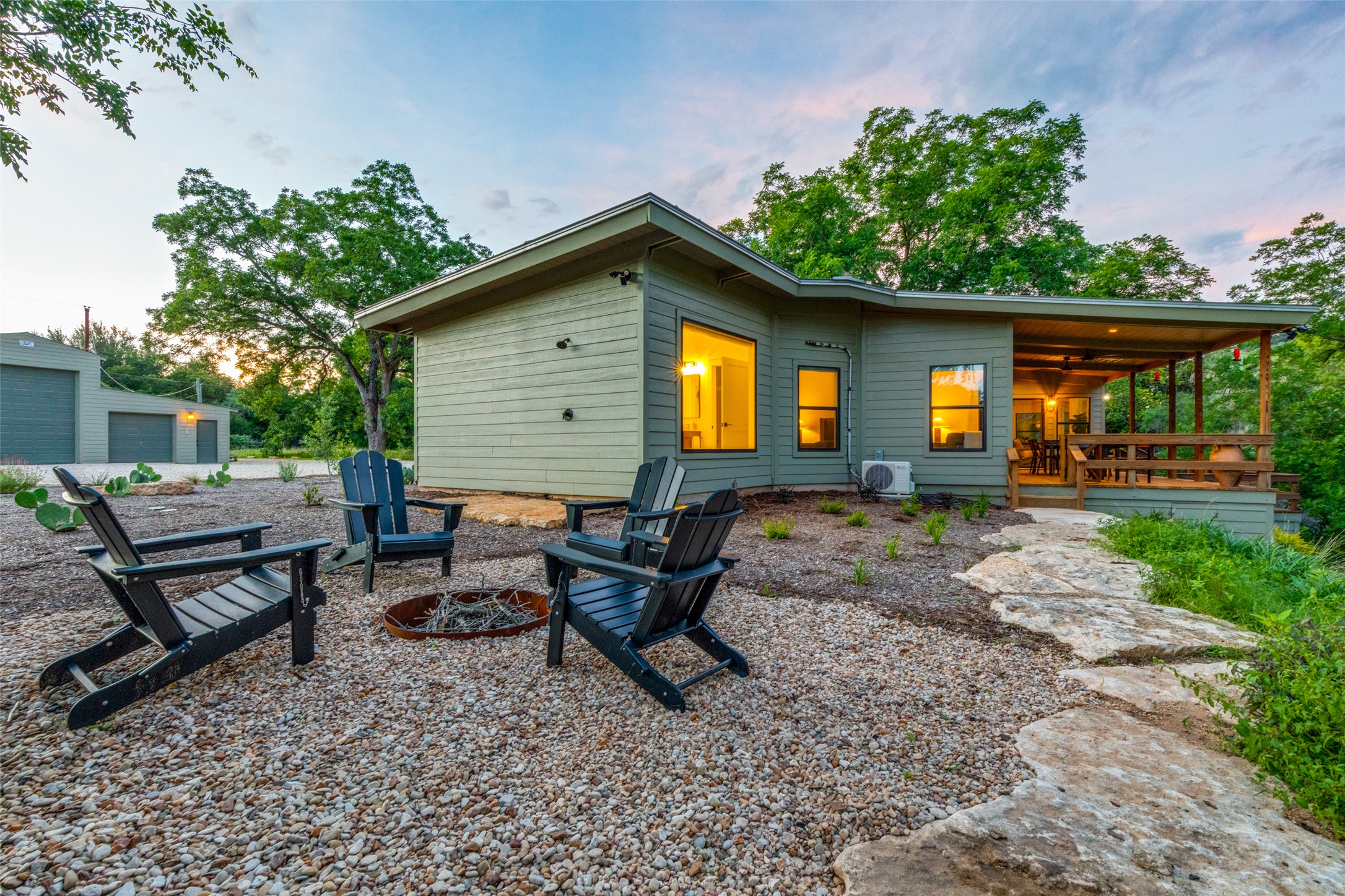 303 Lago Verde Road Austin, TX 78734 - Photo 31 of 39 An inviting fire pit area and a covered back porch offer tranquil outdoor living spaces.
