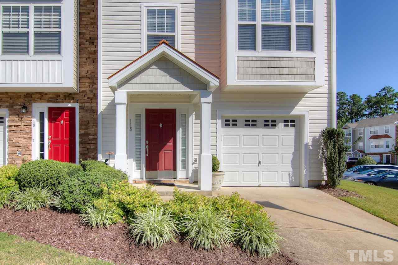 115 Darley Dale Loop Apex, NC 27502 - Photo 2 of 25 a front view of a house with a yard and garage