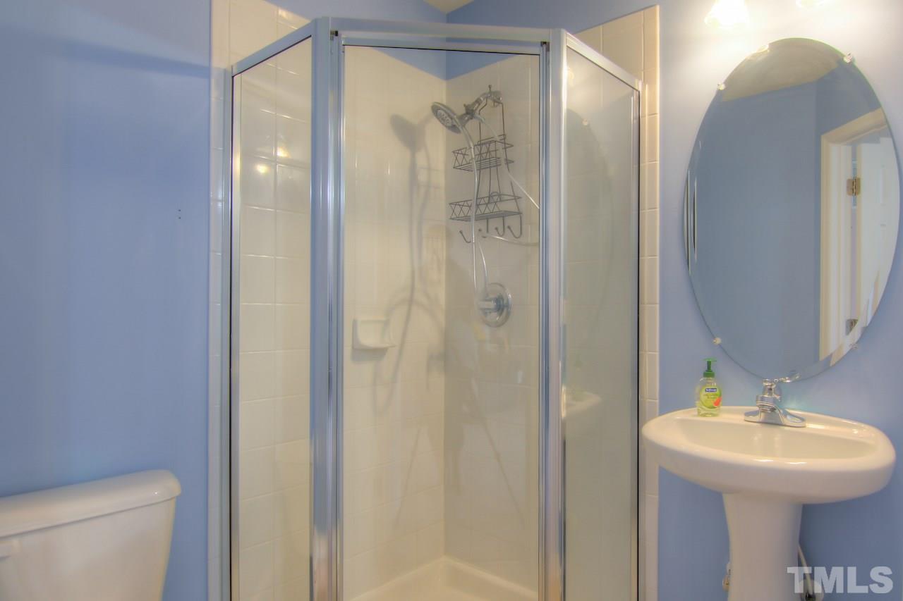 115 Darley Dale Loop Apex, NC 27502 - Photo 15 of 25 a bathroom with a sink toilet and shower