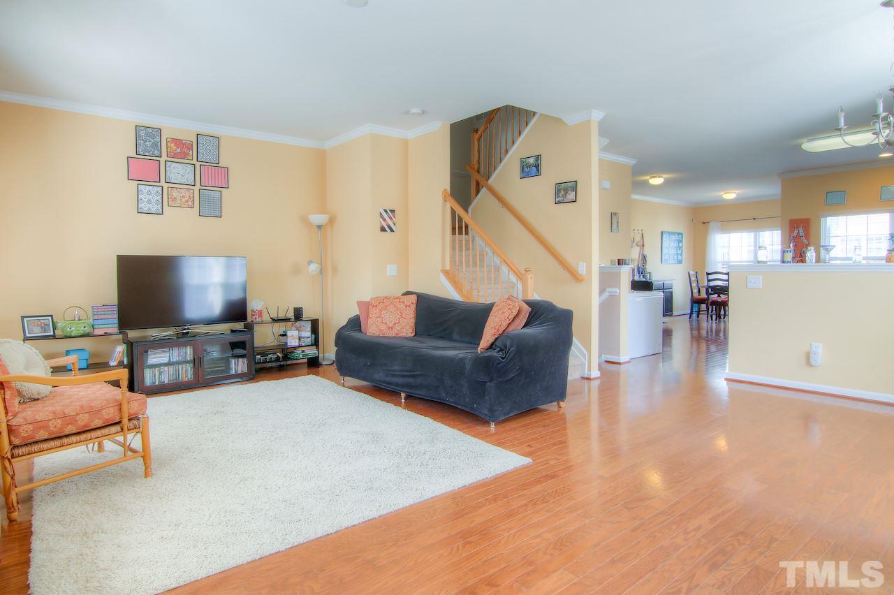 115 Darley Dale Loop Apex, NC 27502 - Photo 19 of 25 a living room with furniture and a flat screen tv
