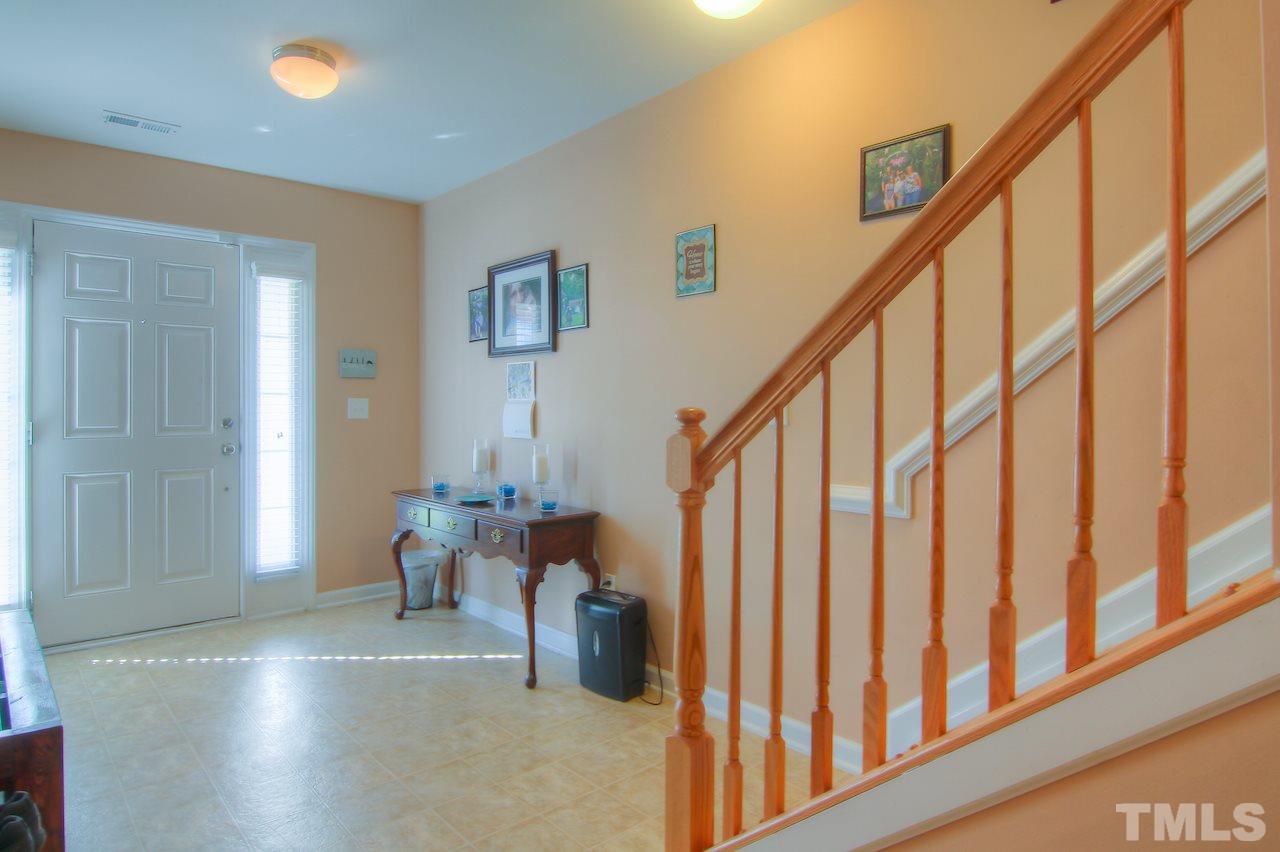 115 Darley Dale Loop Apex, NC 27502 - Photo 3 of 25 a view of entryway and hall with wooden floor