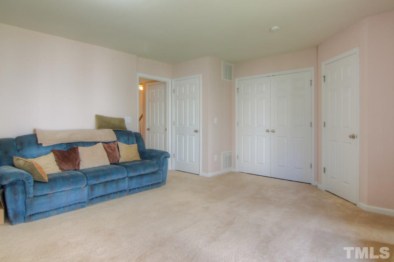 115 Darley Dale Loop Apex, NC 27502 - Photo 21 of 25 a living room with furniture and a couch