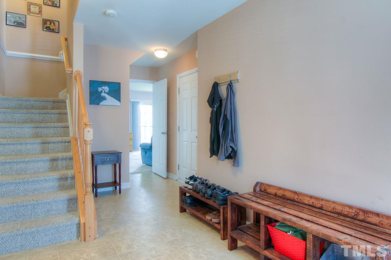 115 Darley Dale Loop Apex, NC 27502 - Photo 22 of 25 a living room with furniture and a baby crib