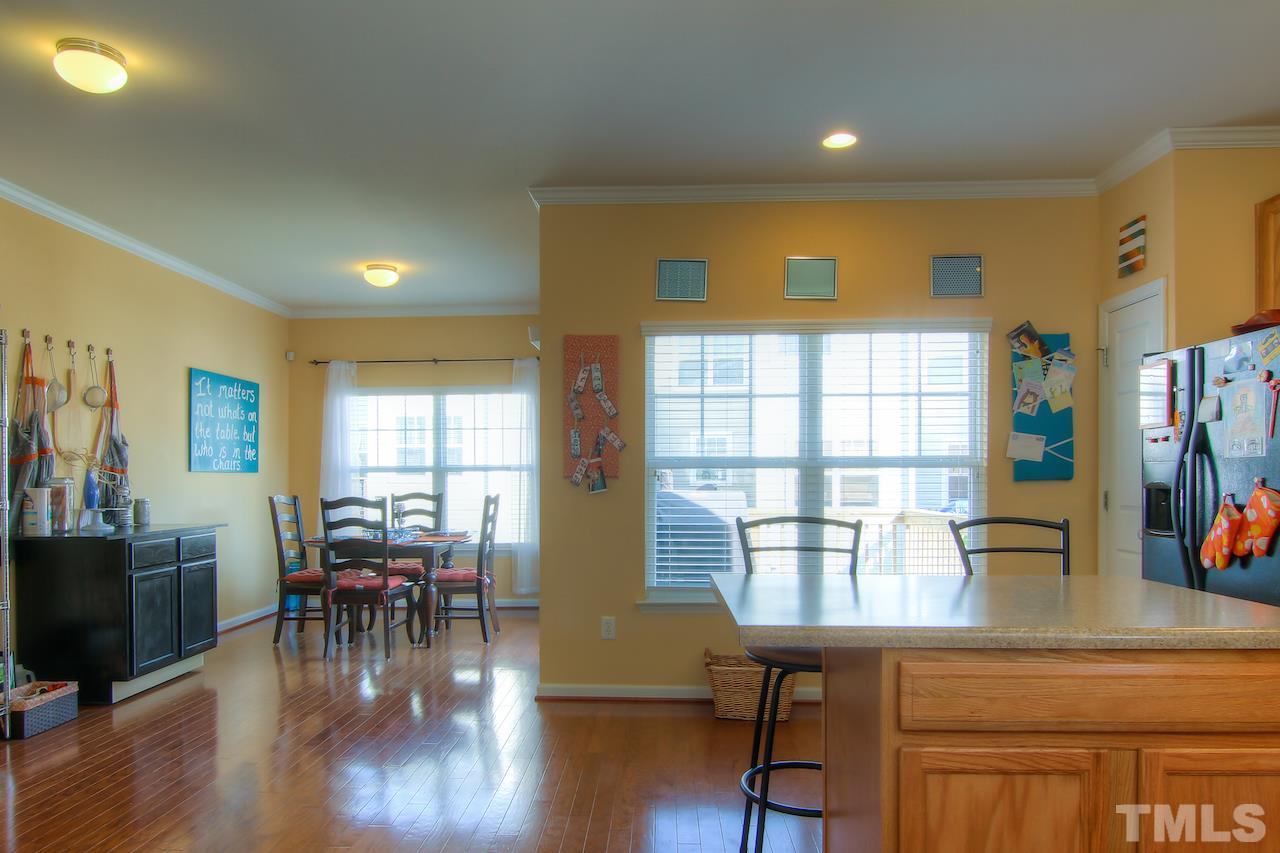 115 Darley Dale Loop Apex, NC 27502 - Photo 7 of 25 a view of a dining room with furniture window and wooden floor