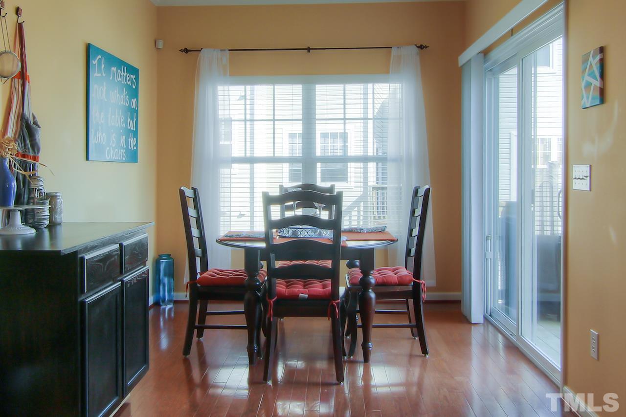 115 Darley Dale Loop Apex, NC 27502 - Photo 8 of 25 a dining room with furniture and wooden floor