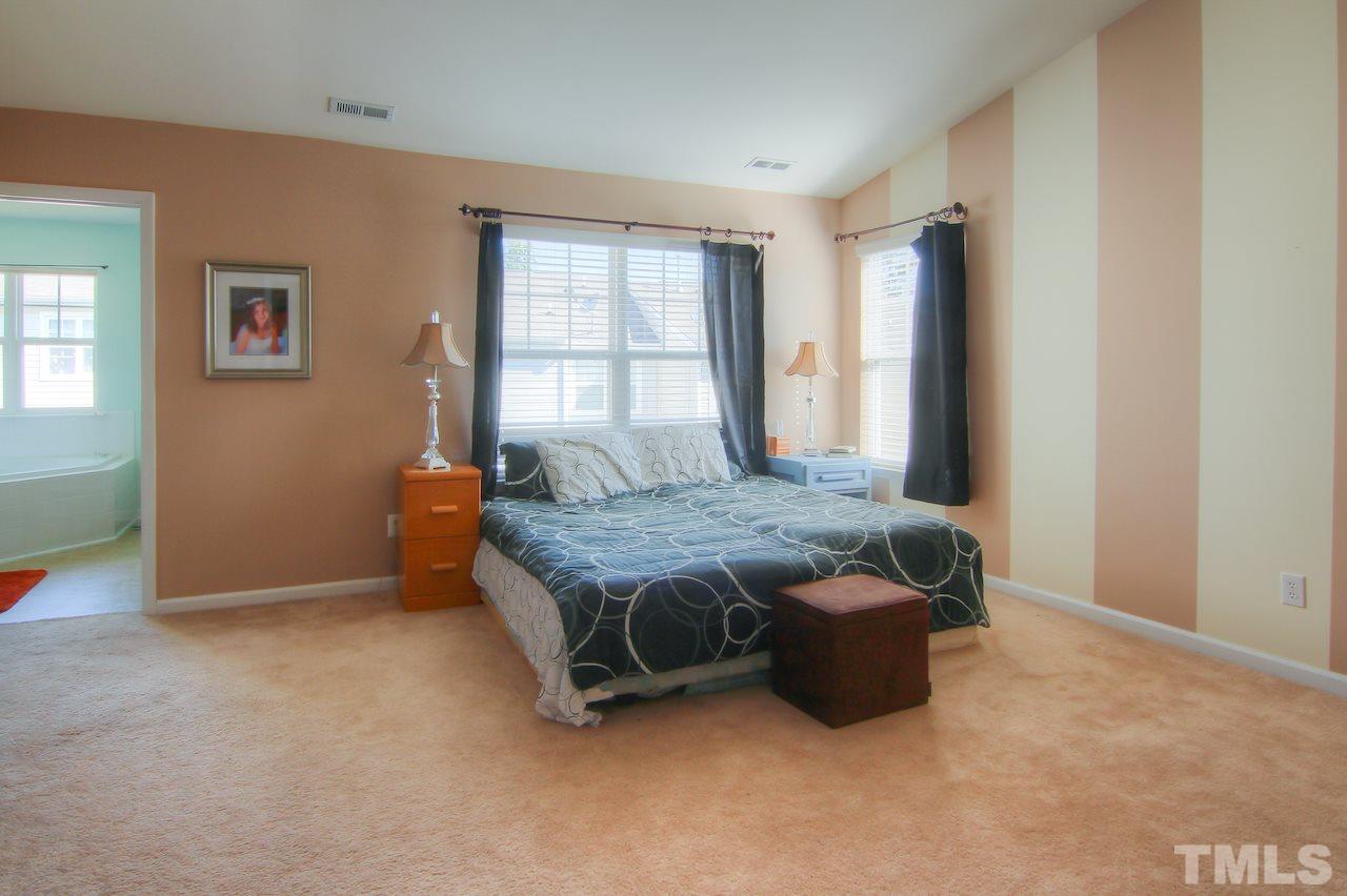 115 Darley Dale Loop Apex, NC 27502 - Photo 10 of 25 a bedroom with a bed and a window