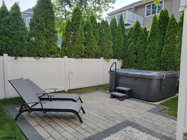 a view of a chairs and bench in a backyard