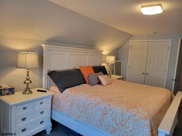 a bedroom with a bed and a night stand