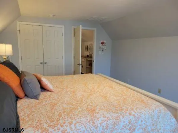 a large bed sitting in a bedroom and closet
