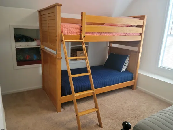 a wooden bench sitting in front of a building