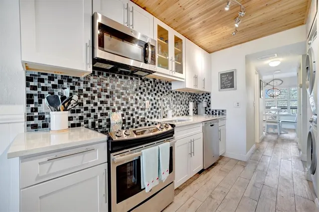 a kitchen with stainless steel appliances a refrigerator and a stove