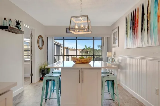 a view of a hallway with furniture and a floor to ceiling window