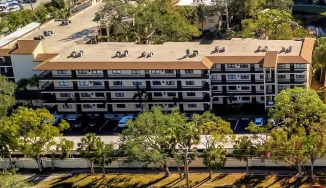 a view of a hallway with wooden floor and windows