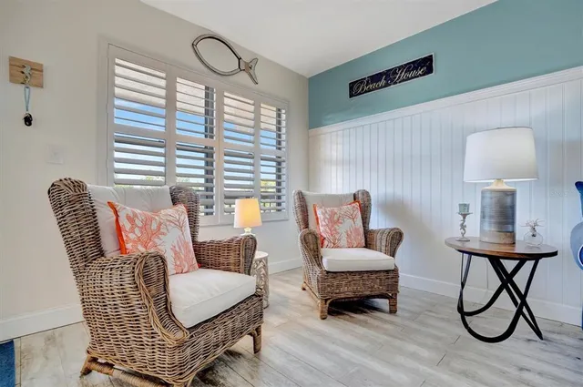 a dining room with furniture and a floor to ceiling window