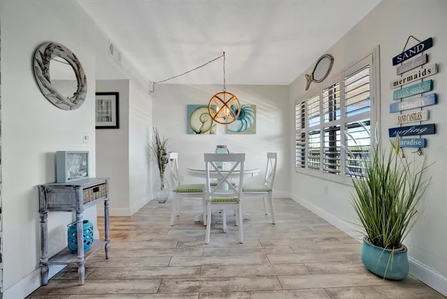 a view of a dining room with furniture and a potted plant