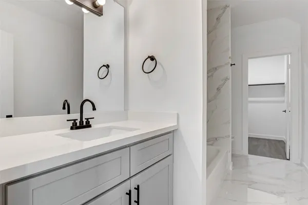 a bathroom with a bathtub and shower