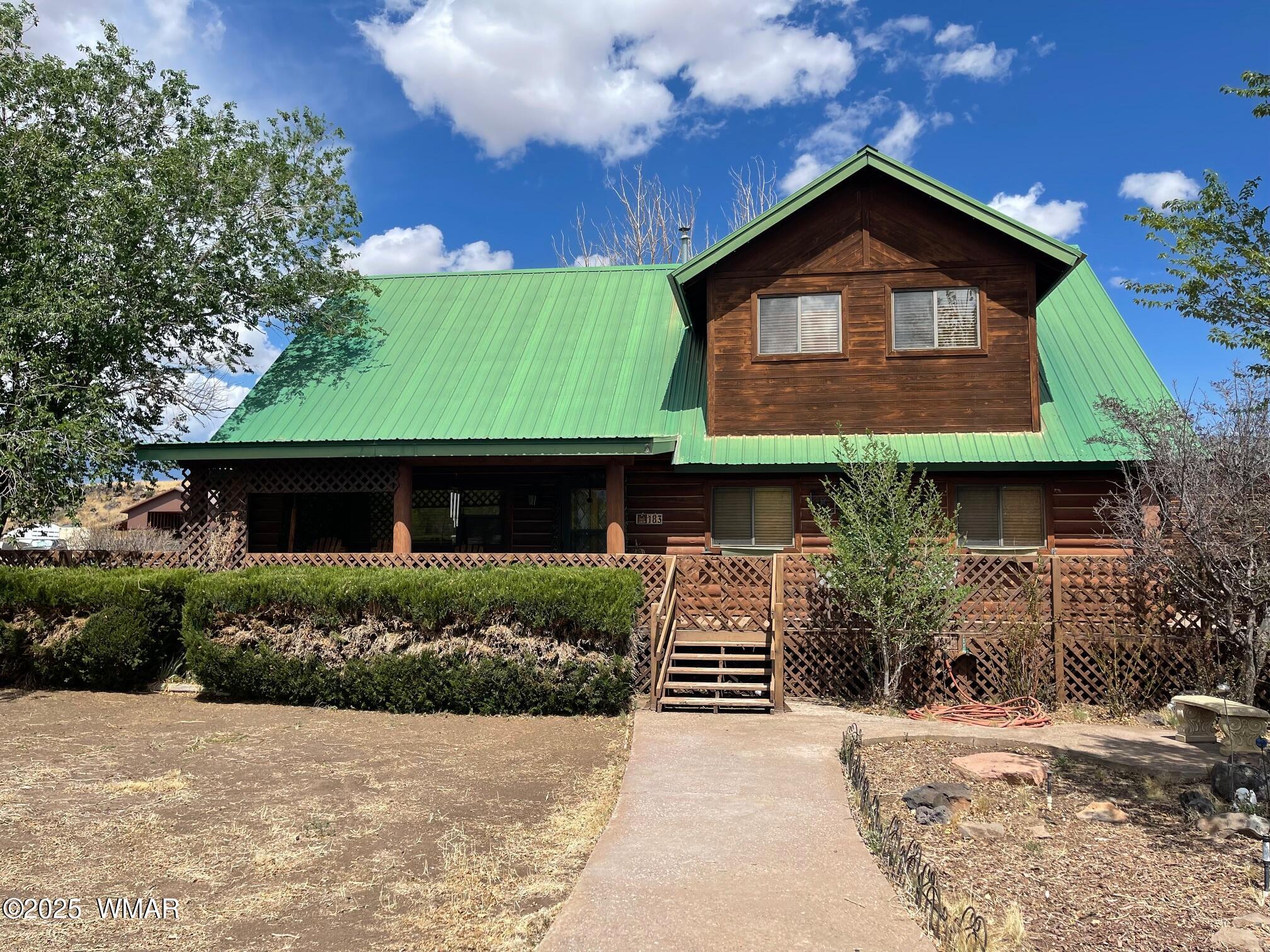 183 North Becker Lake Road Springerville, AZ 85938 - Photo 3 of 41 a front view of a house with a garden