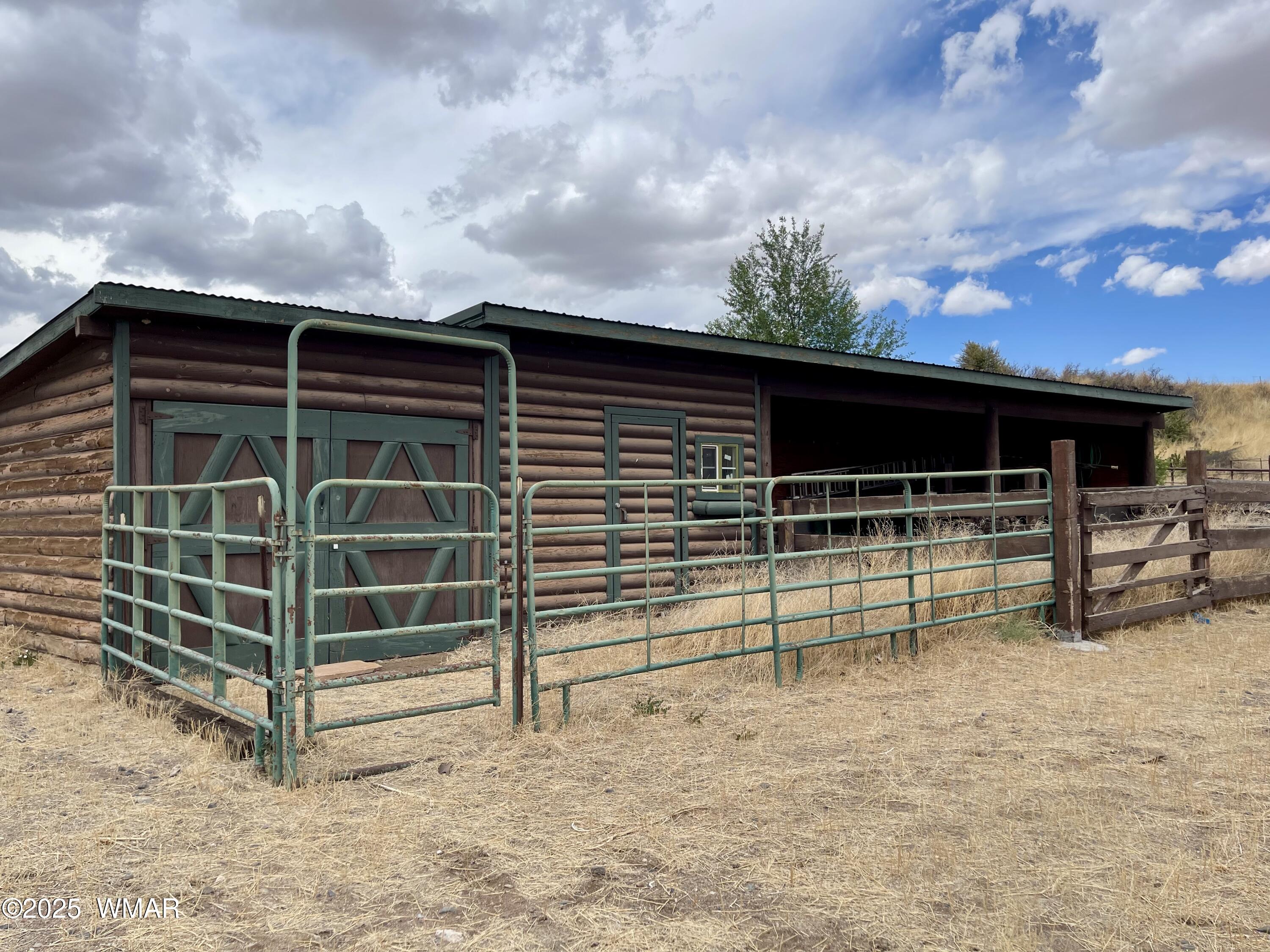 183 North Becker Lake Road Springerville, AZ 85938 - Photo 39 of 41 a view of a house with a yard and wooden fence