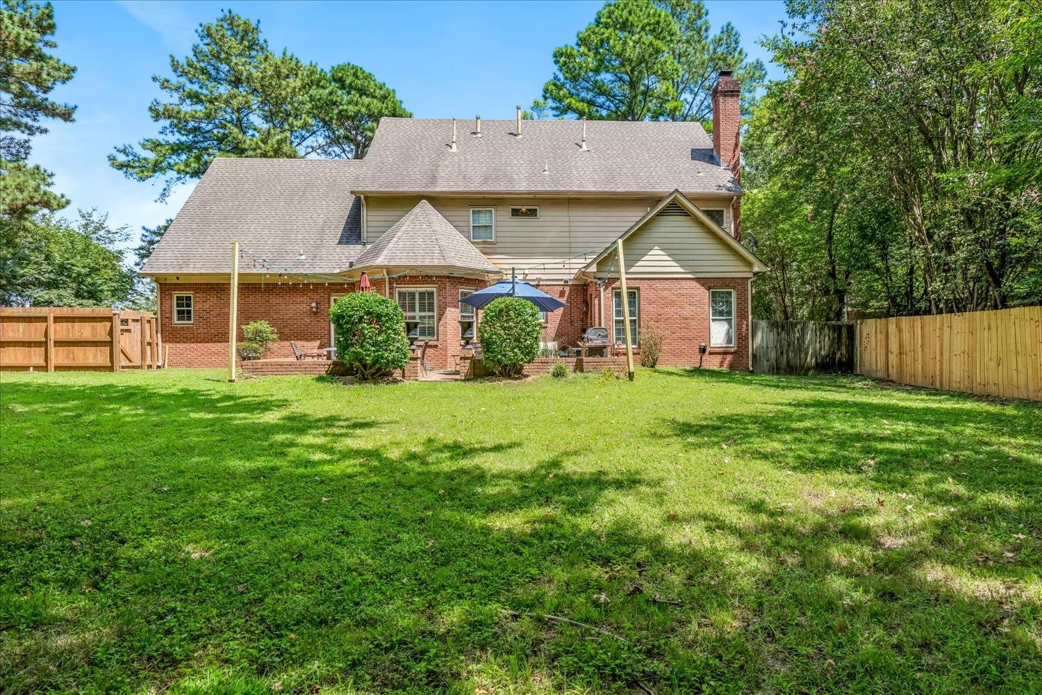 65 Summer Grove Road Memphis, TN 38018 - Photo 33 of 38 Expansive green lawn with mature trees and a privacy fence
