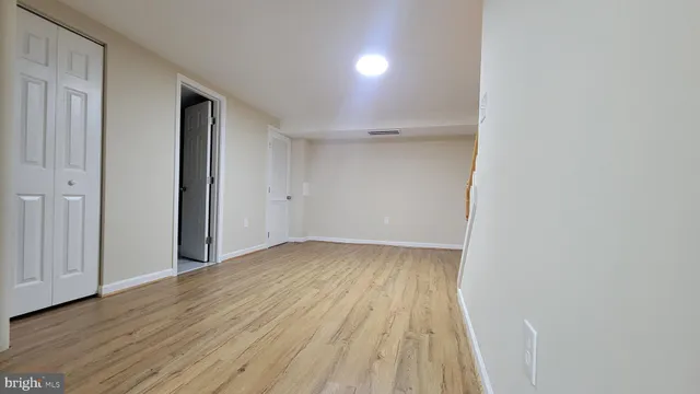 a view of a room with wooden floor