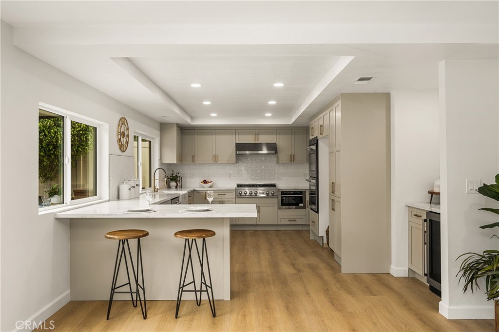 149 Bluegrass Street Brea, CA 92821 - Photo 27 of 60 a kitchen with stainless steel appliances granite countertop a dining table chairs refrigerator and sink