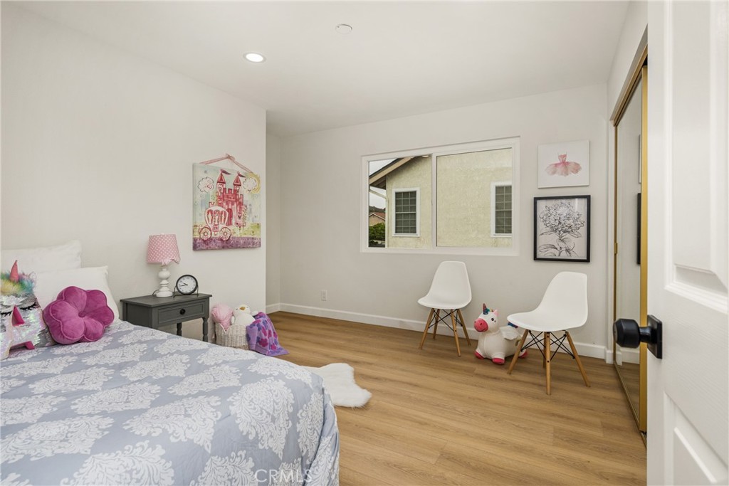 149 Bluegrass Street Brea, CA 92821 - Photo 54 of 60 a bedroom with a bed and wooden floor