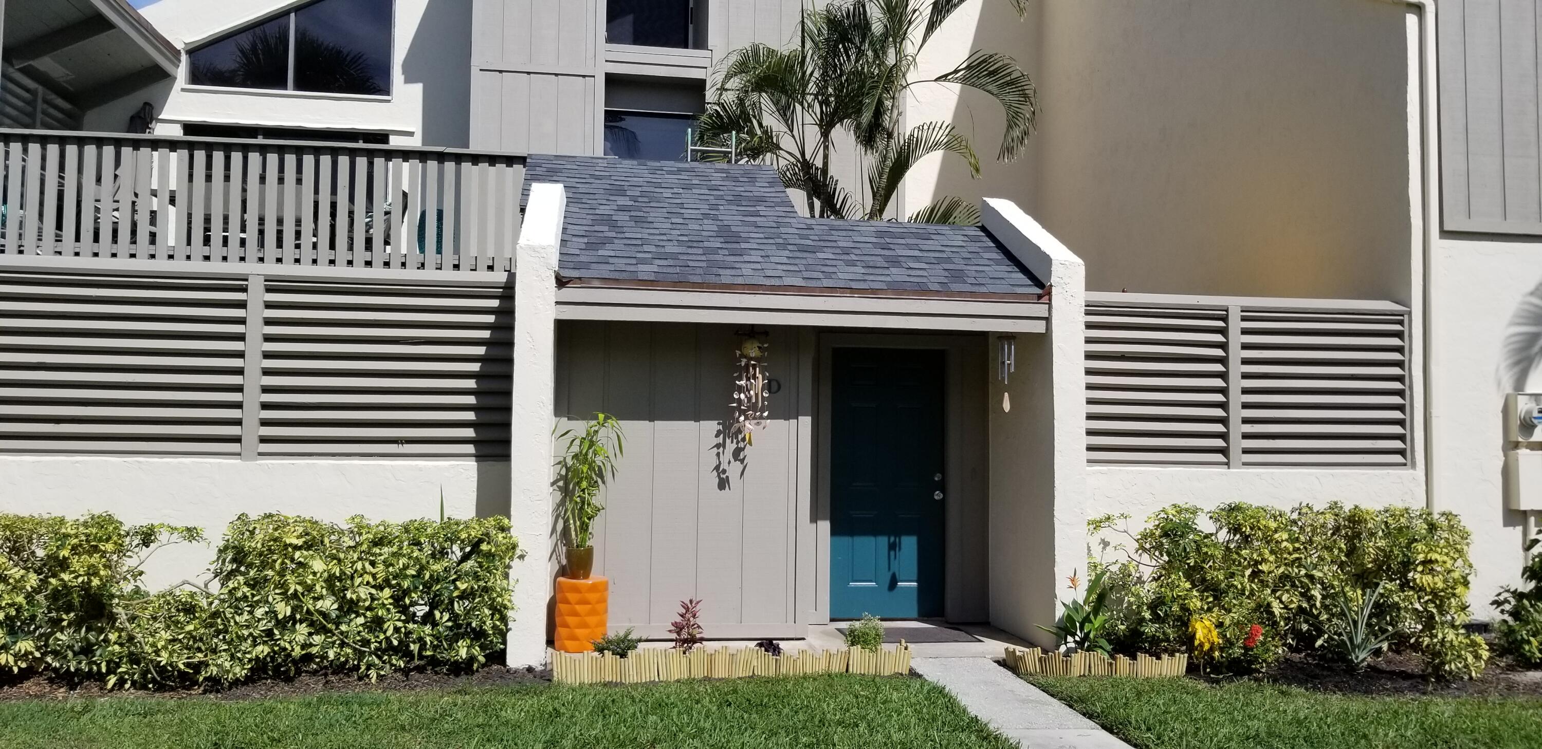 1605 Highway 1, Unit 4D Jupiter, FL 33477 - Photo 1 of 30 a front view of a house with a yard