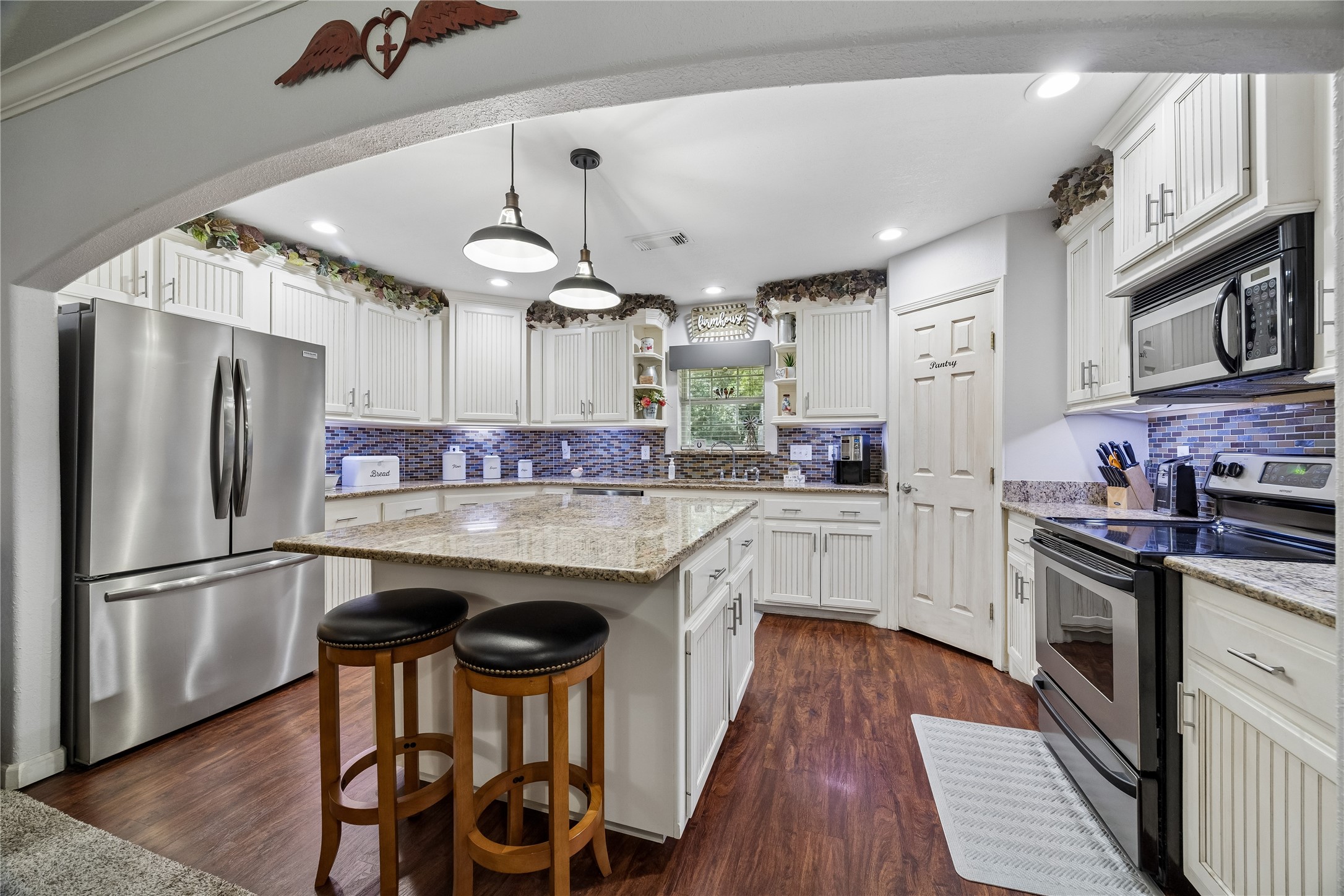 The kitchen features beautiful cabinetry, granite countertops, and a large center island