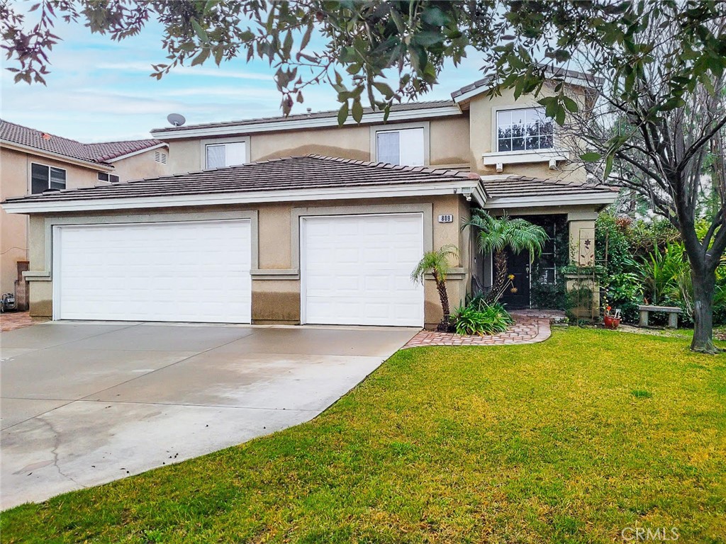 a front view of a house with a yard and garage