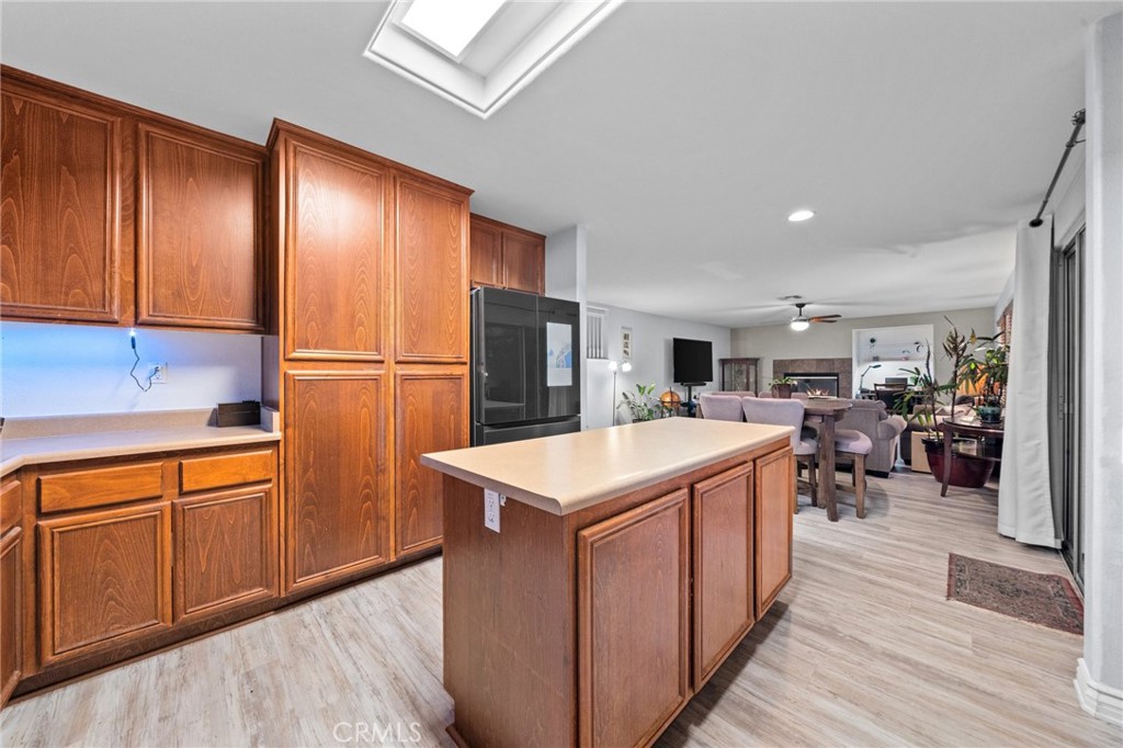 809 Classic Avenue Beaumont, CA 92223 - Photo 21 of 41 a kitchen that has a lot of cabinets in it and wooden floors