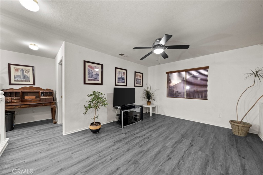 809 Classic Avenue Beaumont, CA 92223 - Photo 22 of 41 a living room with furniture and a wooden floor