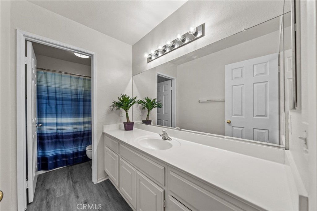809 Classic Avenue Beaumont, CA 92223 - Photo 26 of 41 a bathroom with a sink and a mirror
