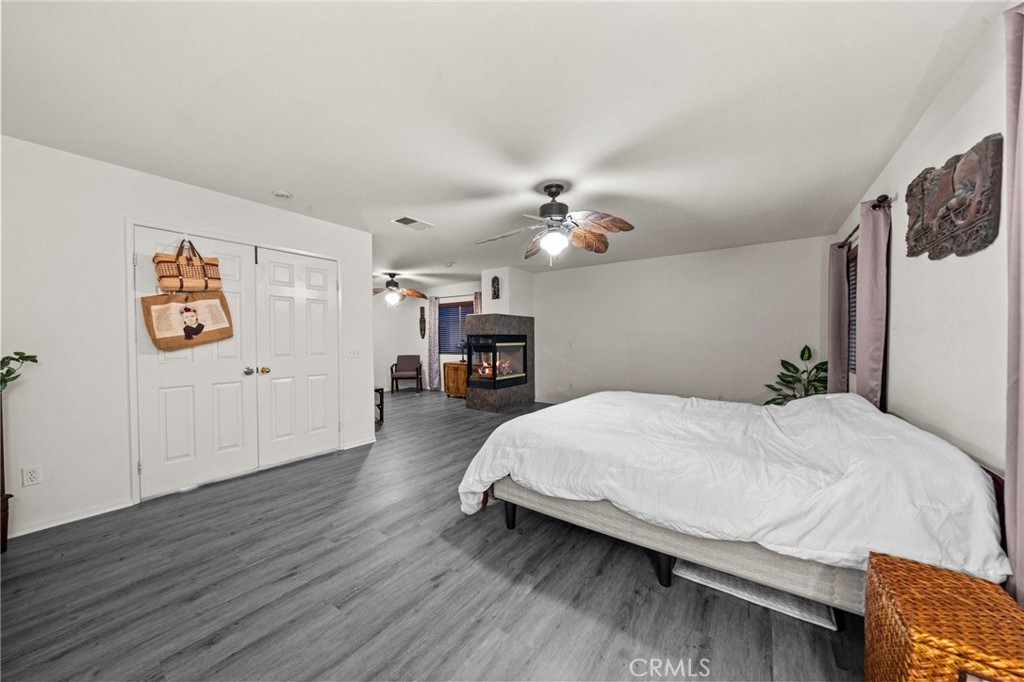 809 Classic Avenue Beaumont, CA 92223 - Photo 28 of 41 a spacious bedroom with a bed and wooden floor