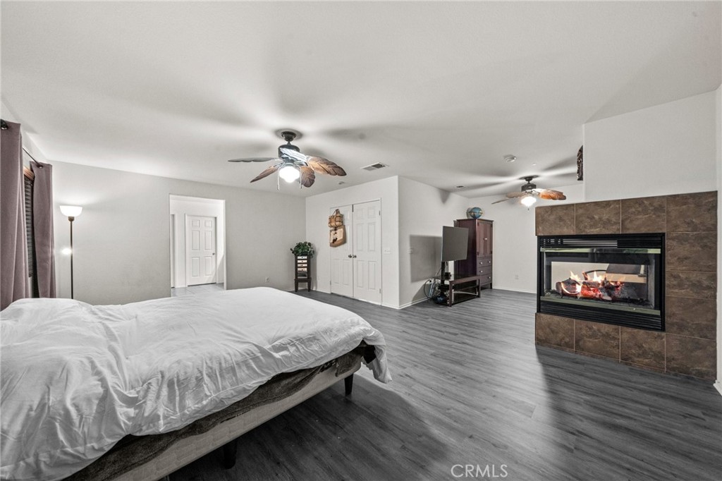 809 Classic Avenue Beaumont, CA 92223 - Photo 29 of 41 a spacious bedroom with a bed and a fireplace