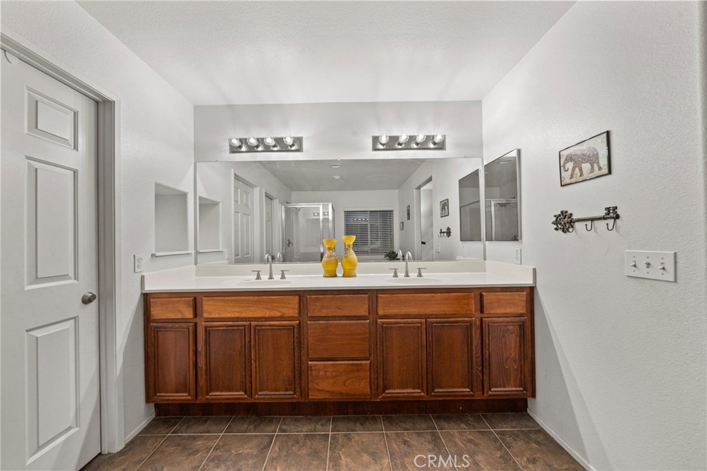 809 Classic Avenue Beaumont, CA 92223 - Photo 35 of 41 a spacious bathroom with a double vanity sink and a mirror