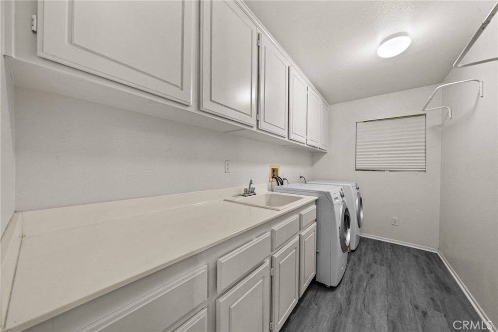 809 Classic Avenue Beaumont, CA 92223 - Photo 36 of 41 a utility room with cabinets washer and dryer
