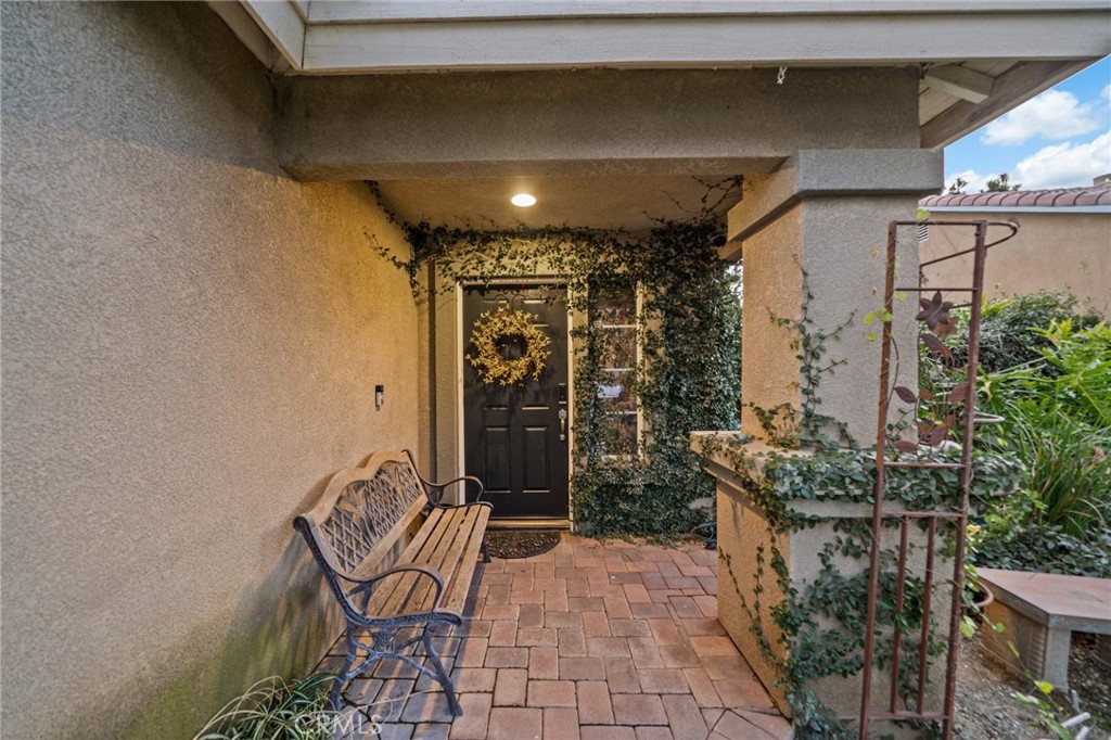 809 Classic Avenue Beaumont, CA 92223 - Photo 6 of 41 a view of a porch with chairs and potted plants