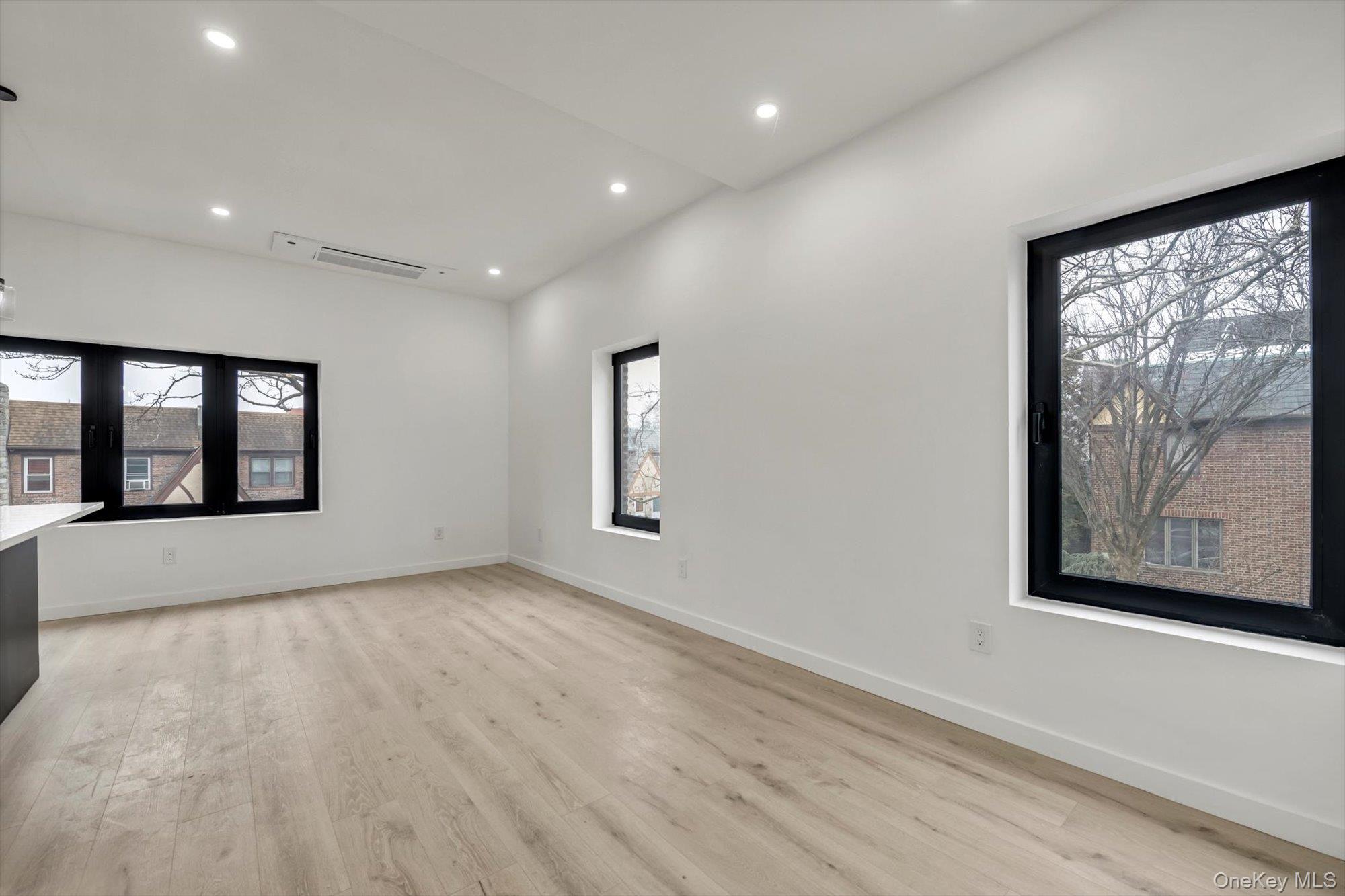 85-45 67th Road Queens, NY 11374 - Photo 14 of 28 a view of an empty room with window and wooden floor