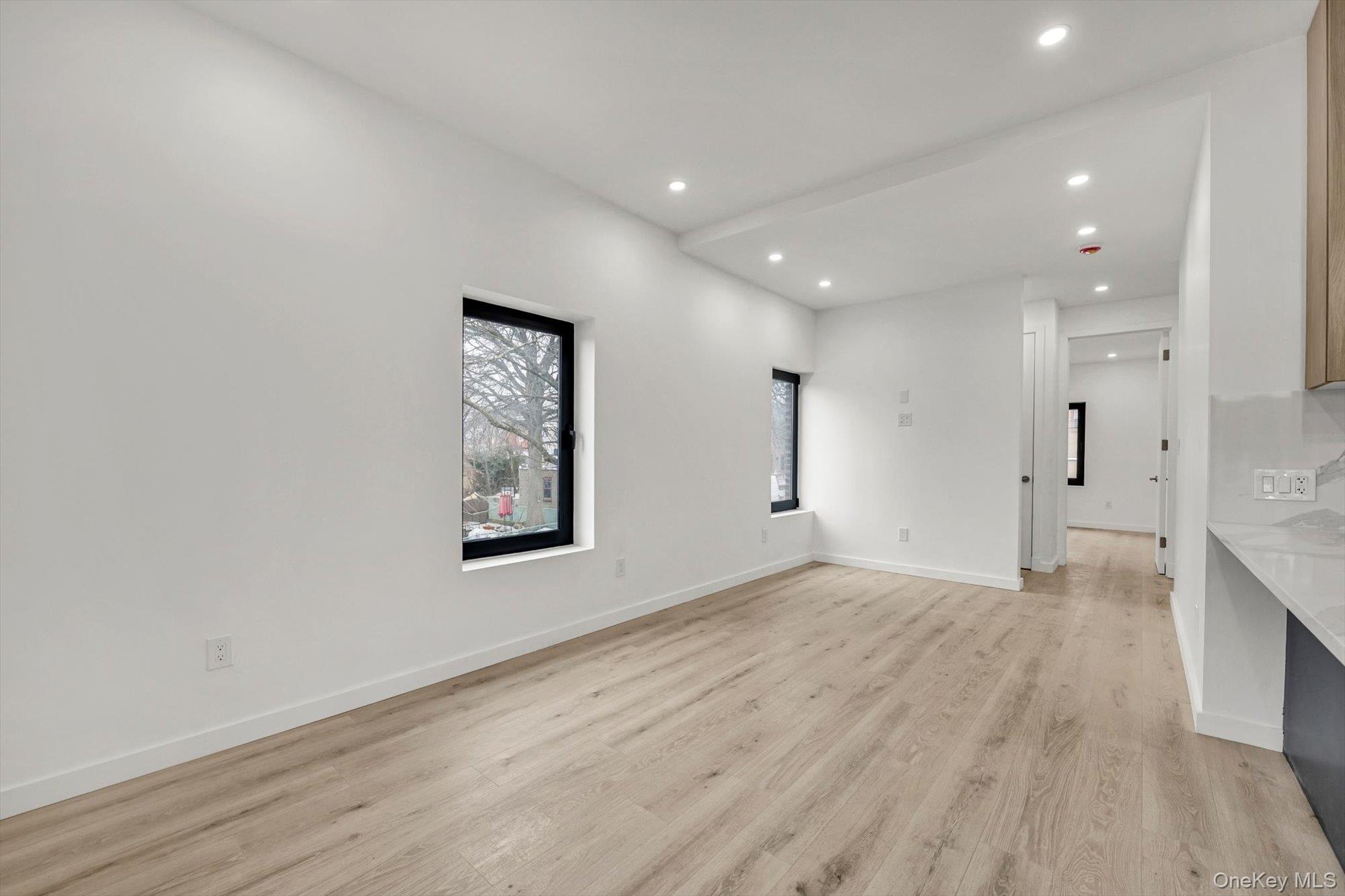 85-45 67th Road Queens, NY 11374 - Photo 15 of 28 a view of an empty room with wooden floor and a window