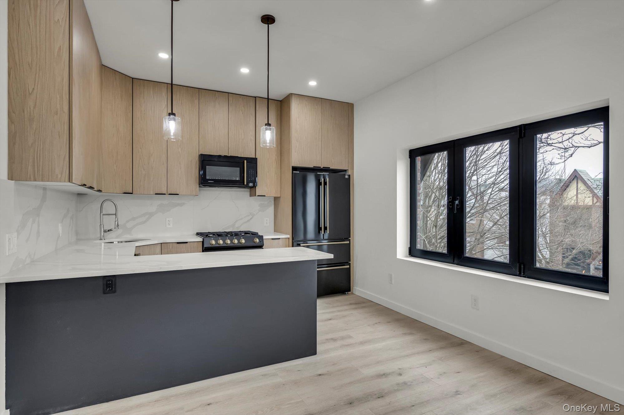 85-45 67th Road Queens, NY 11374 - Photo 17 of 28 a kitchen with stainless steel appliances granite countertop a sink a stove and a refrigerator