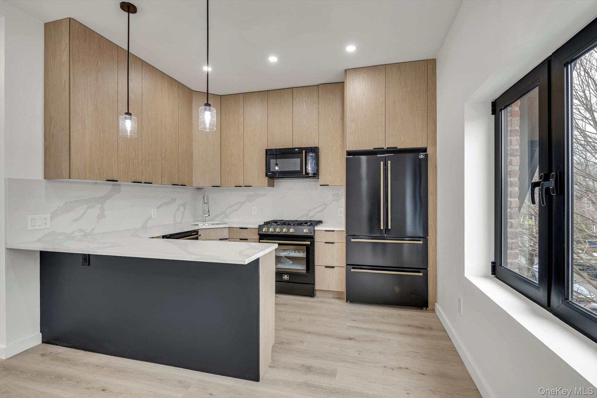 85-45 67th Road Queens, NY 11374 - Photo 18 of 28 a kitchen with stainless steel appliances granite countertop a refrigerator a sink a stove and a refrigerator with wooden floor